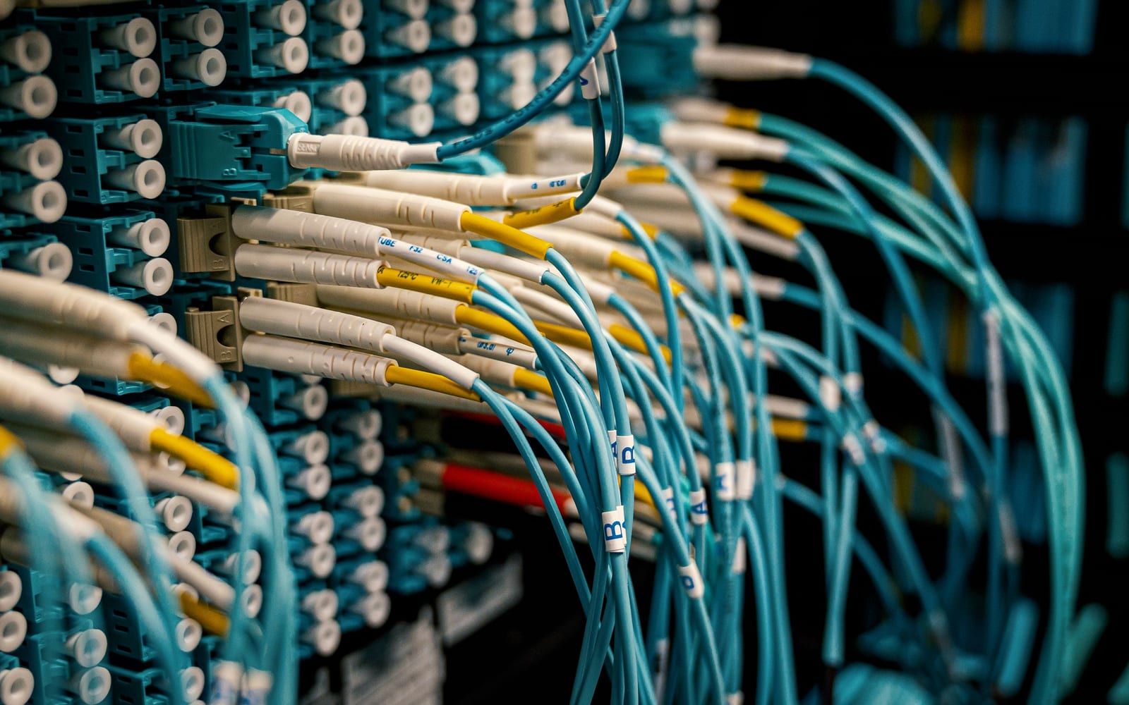 An engineer working beside servers in a data centre.