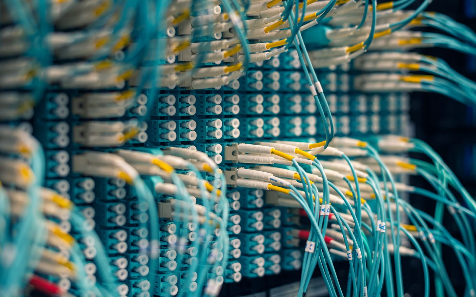 An engineer working beside servers in a data centre.