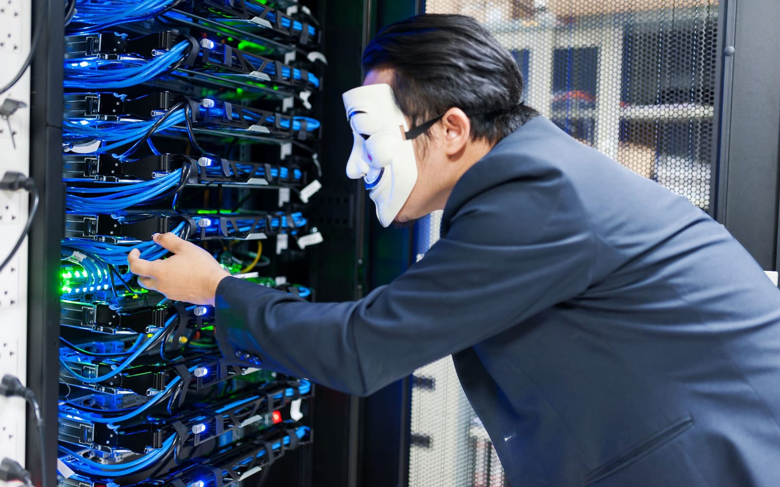 An engineer working beside servers in a data centre.