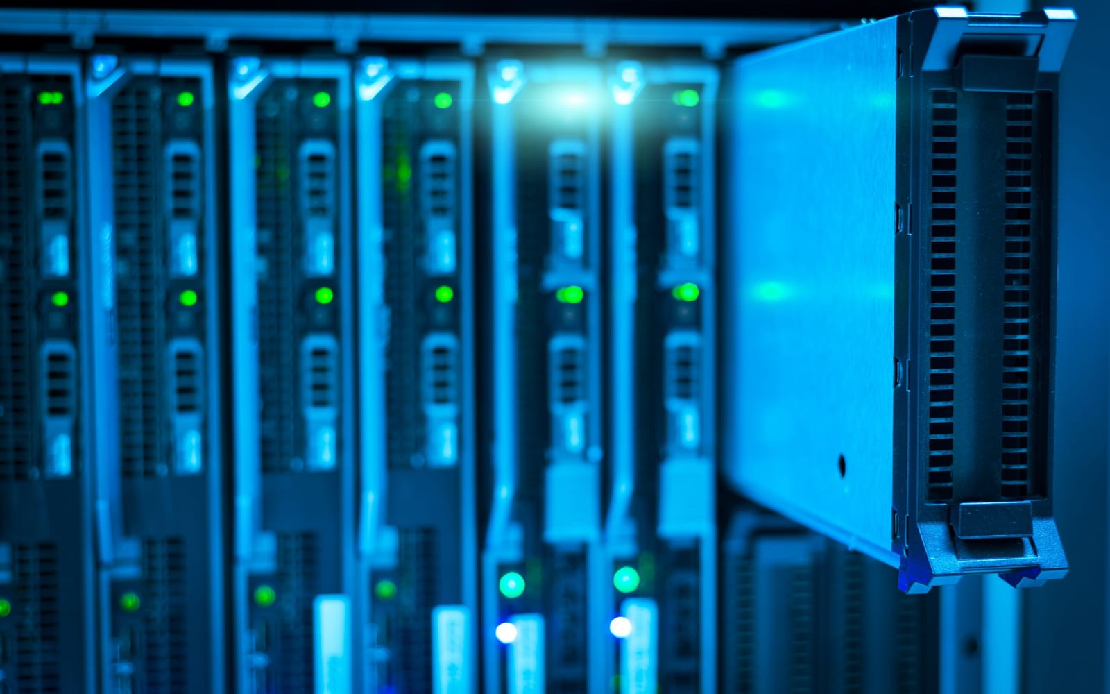 An engineer working beside servers in a data centre.