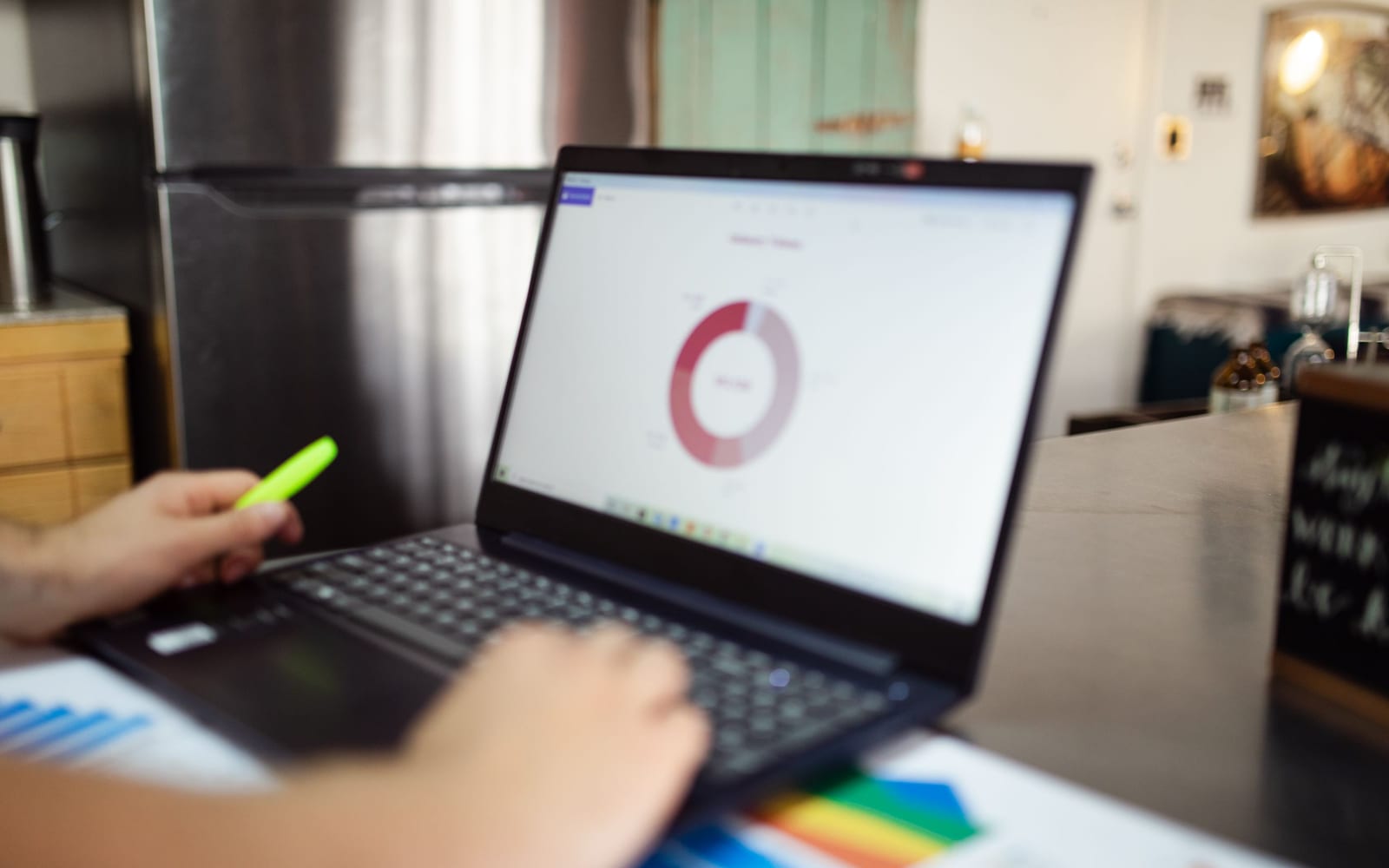 An analyst reviewing figures on a laptop in an office.