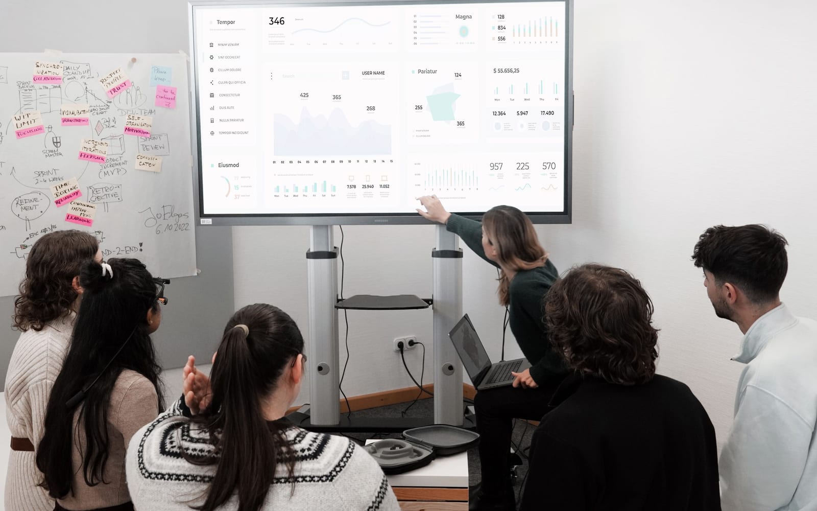 An analyst reviewing figures on a laptop in an office.