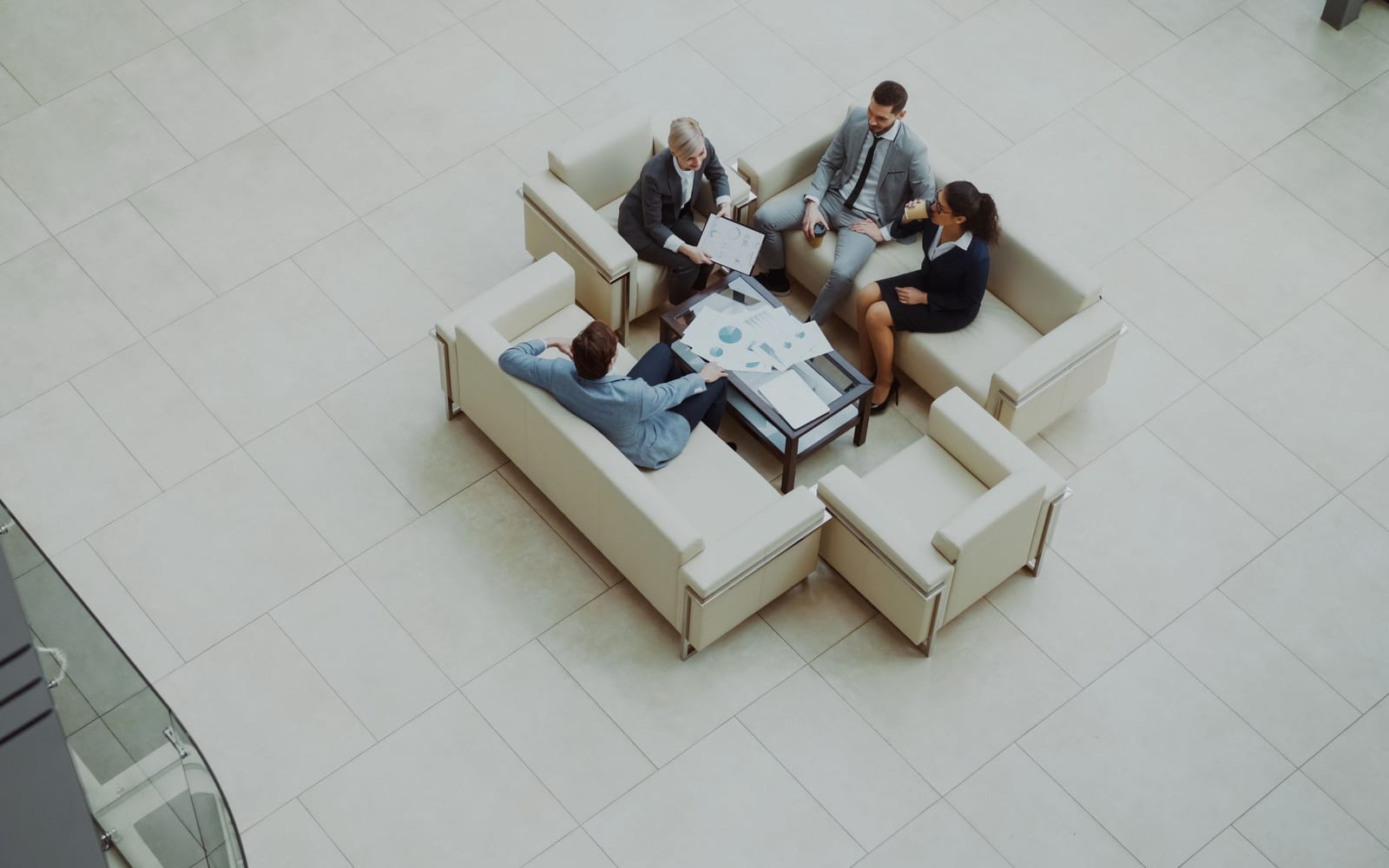 An enterprise meeting in a glass-walled conference room.