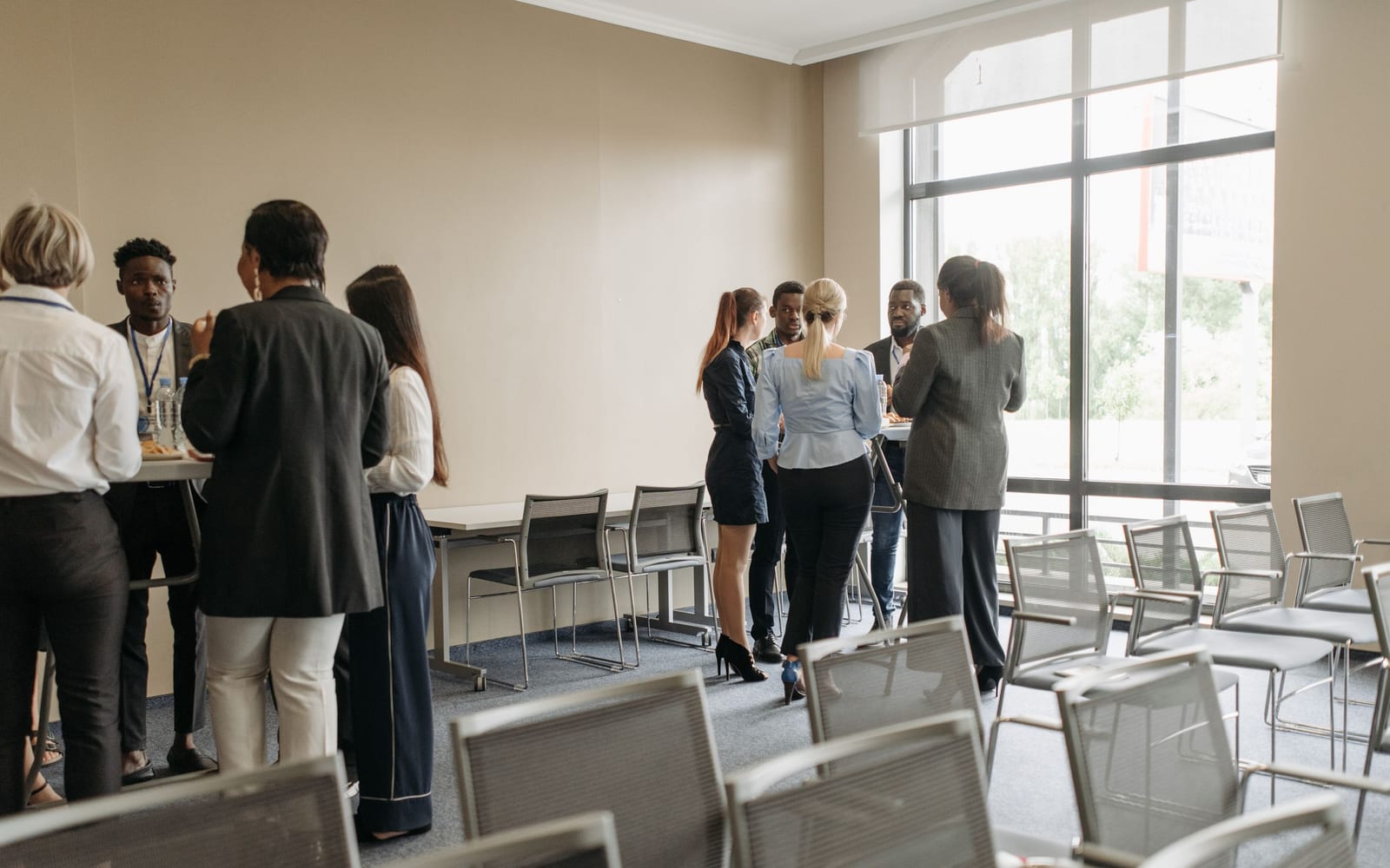 An enterprise meeting in a glass-walled conference room.