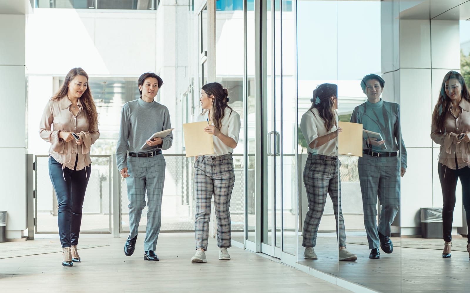 An enterprise meeting in a glass-walled conference room.