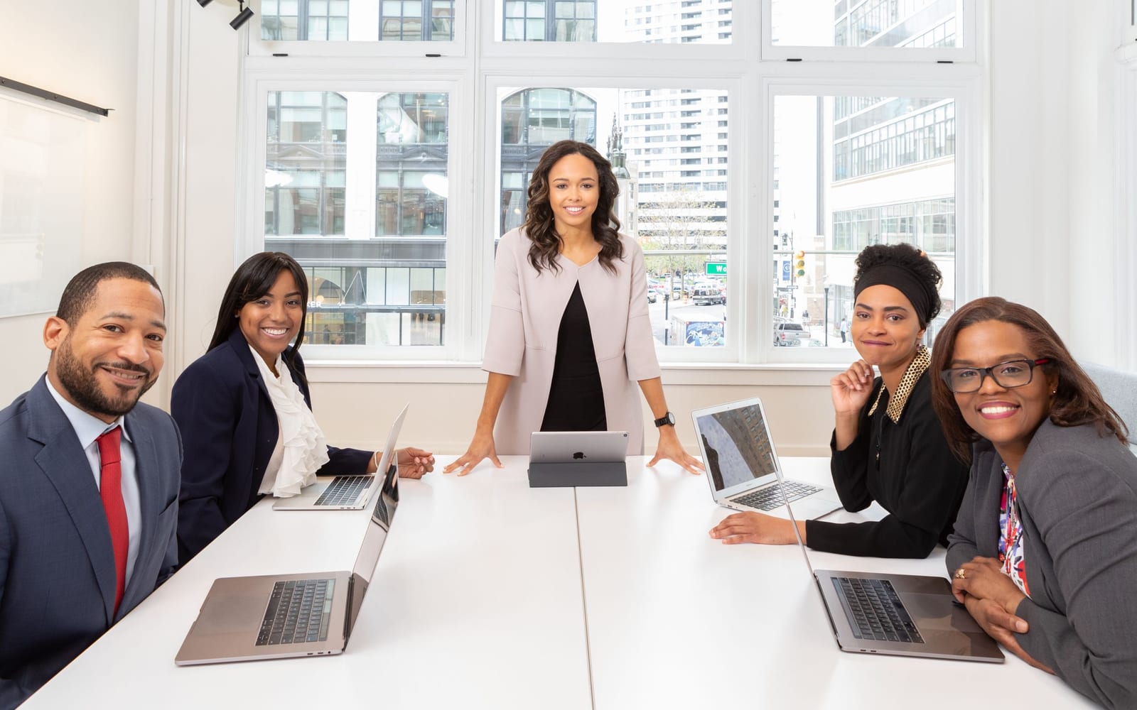 An enterprise meeting in a glass-walled conference room.