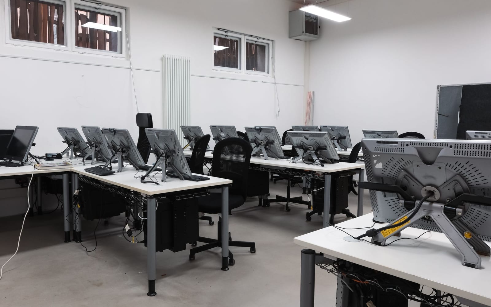 An engineer working beside servers in a data centre.