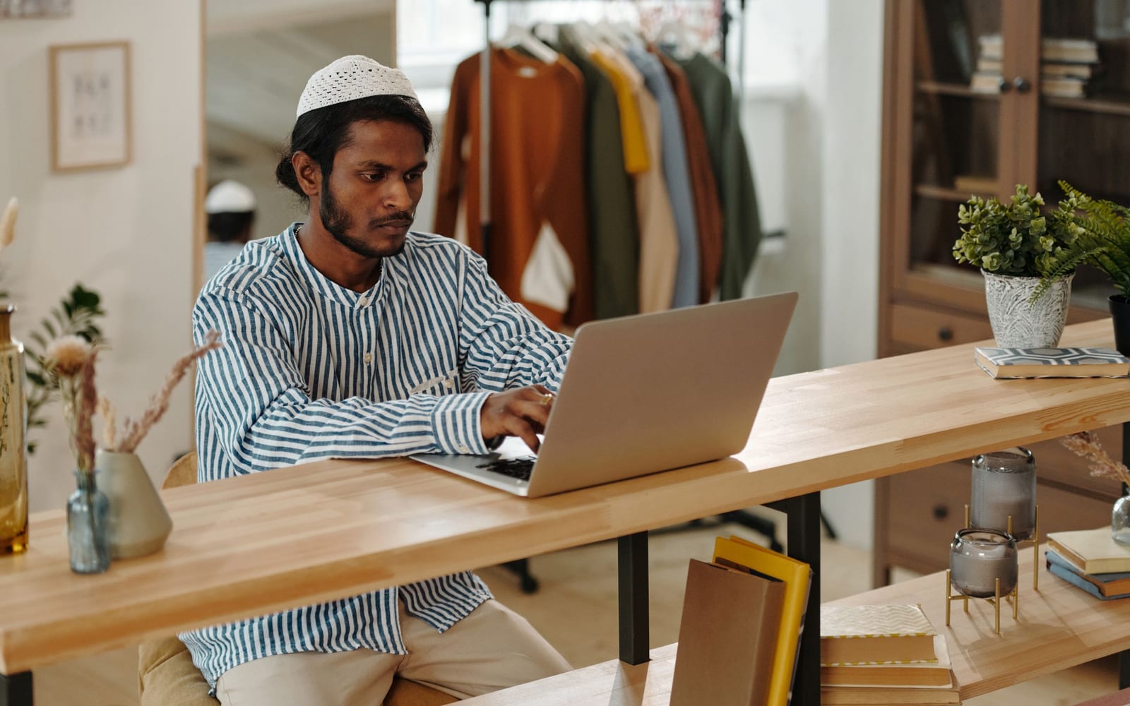 An analyst reviewing figures on a laptop in an office.