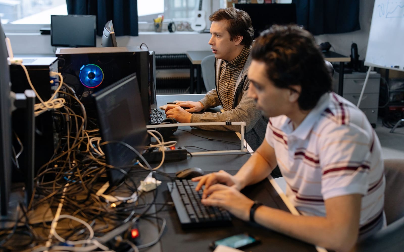 An engineer working beside servers in a data centre.