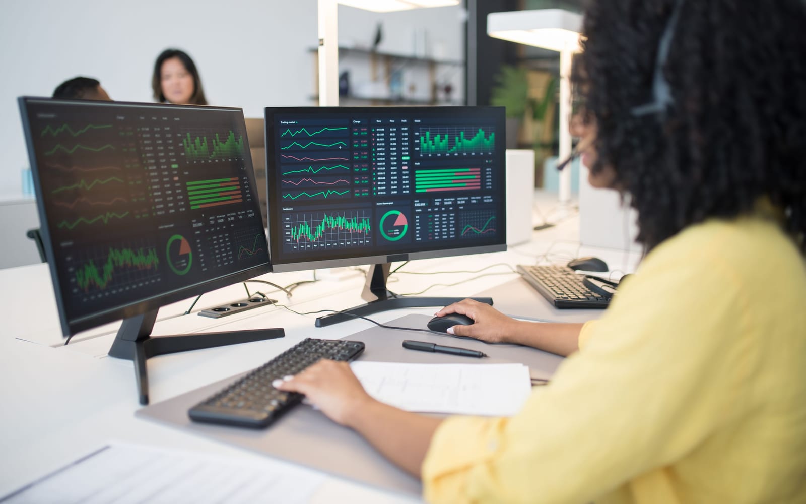 An analyst reviewing figures on a laptop in an office.