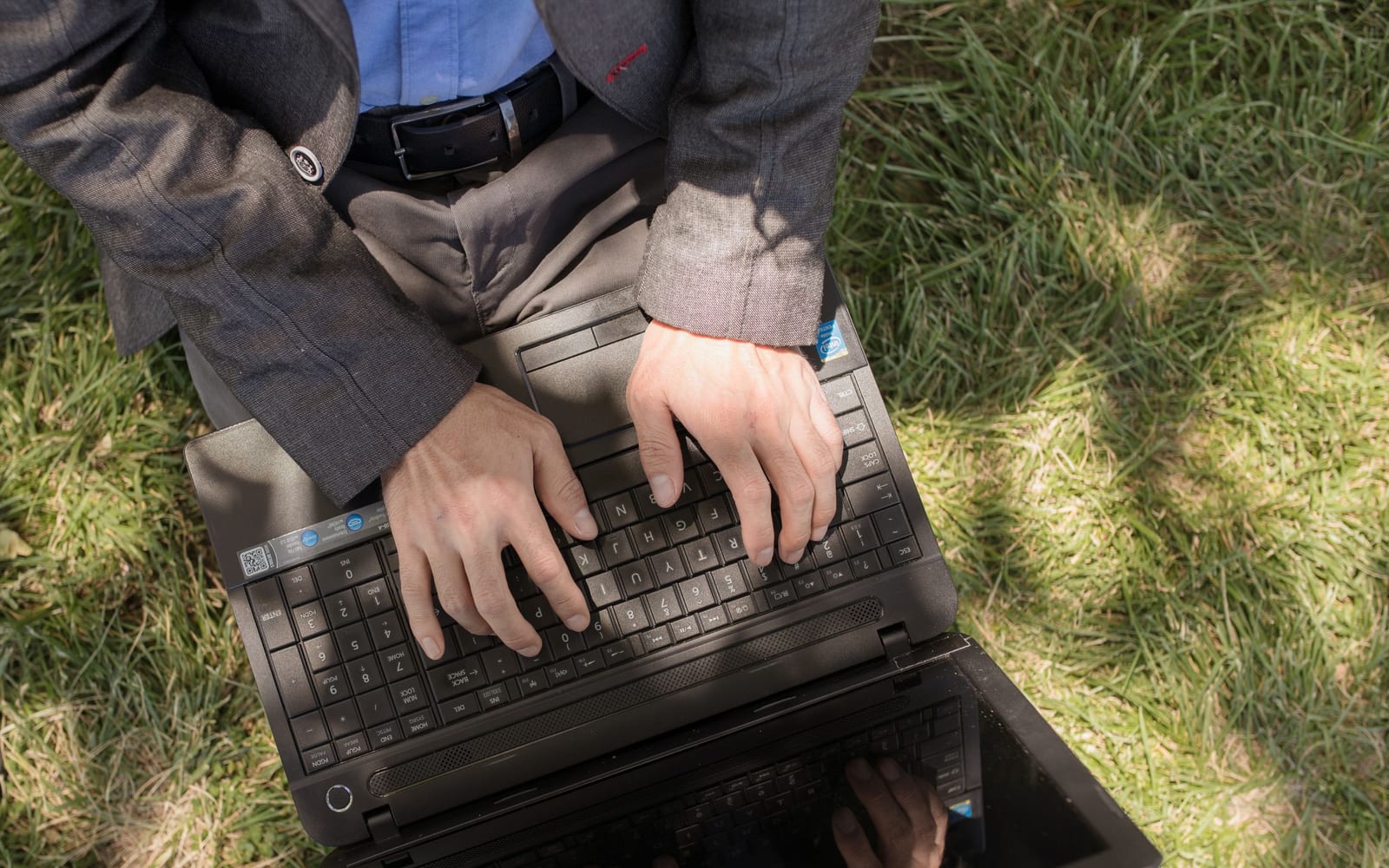 An analyst reviewing figures on a laptop in an office.
