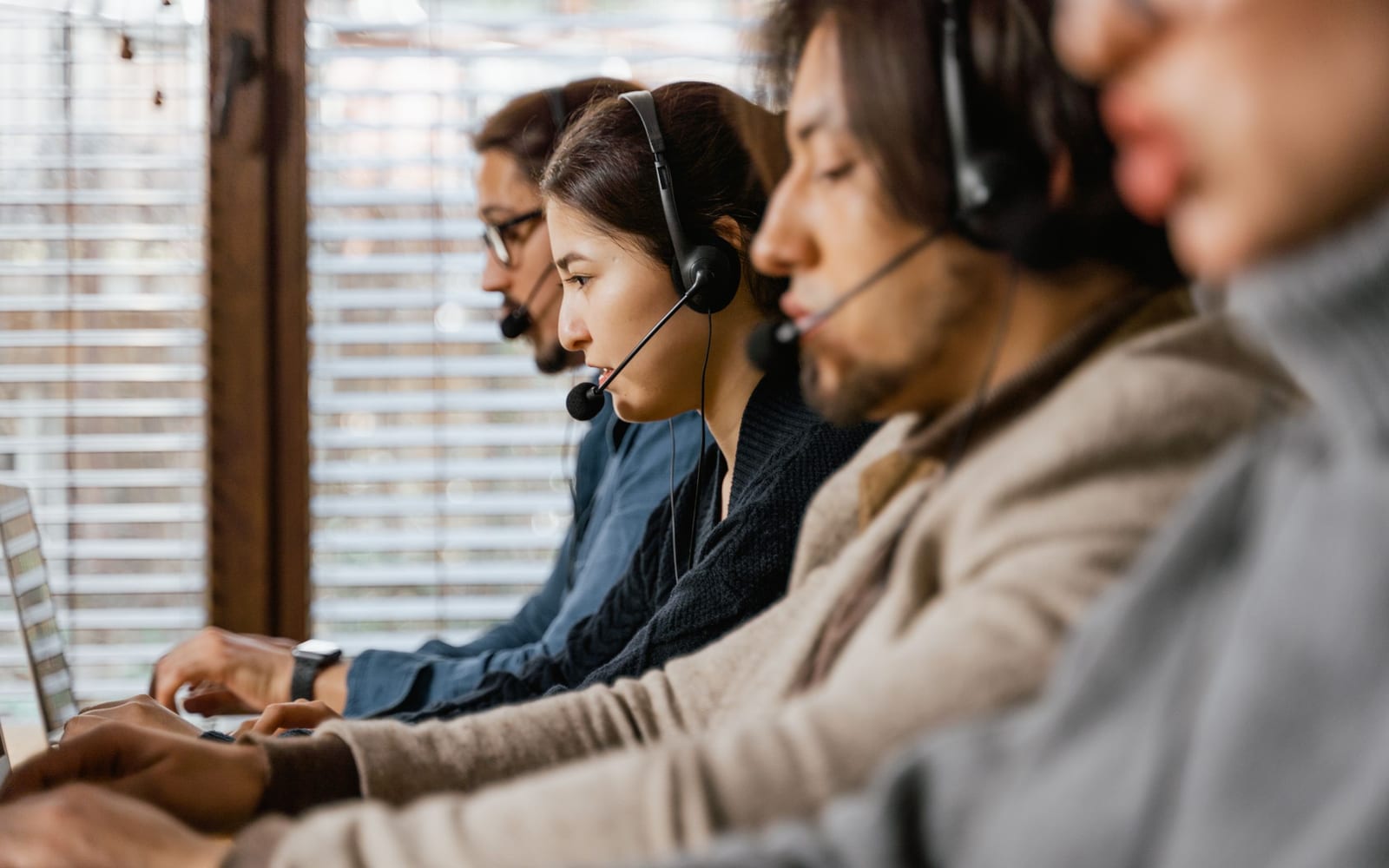 A service agent working with a headset in a contact centre.