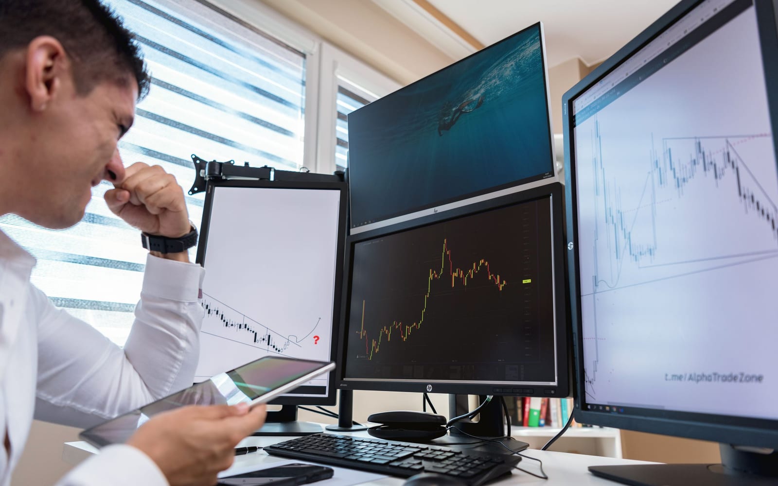 An analyst reviewing figures on a laptop in an office.