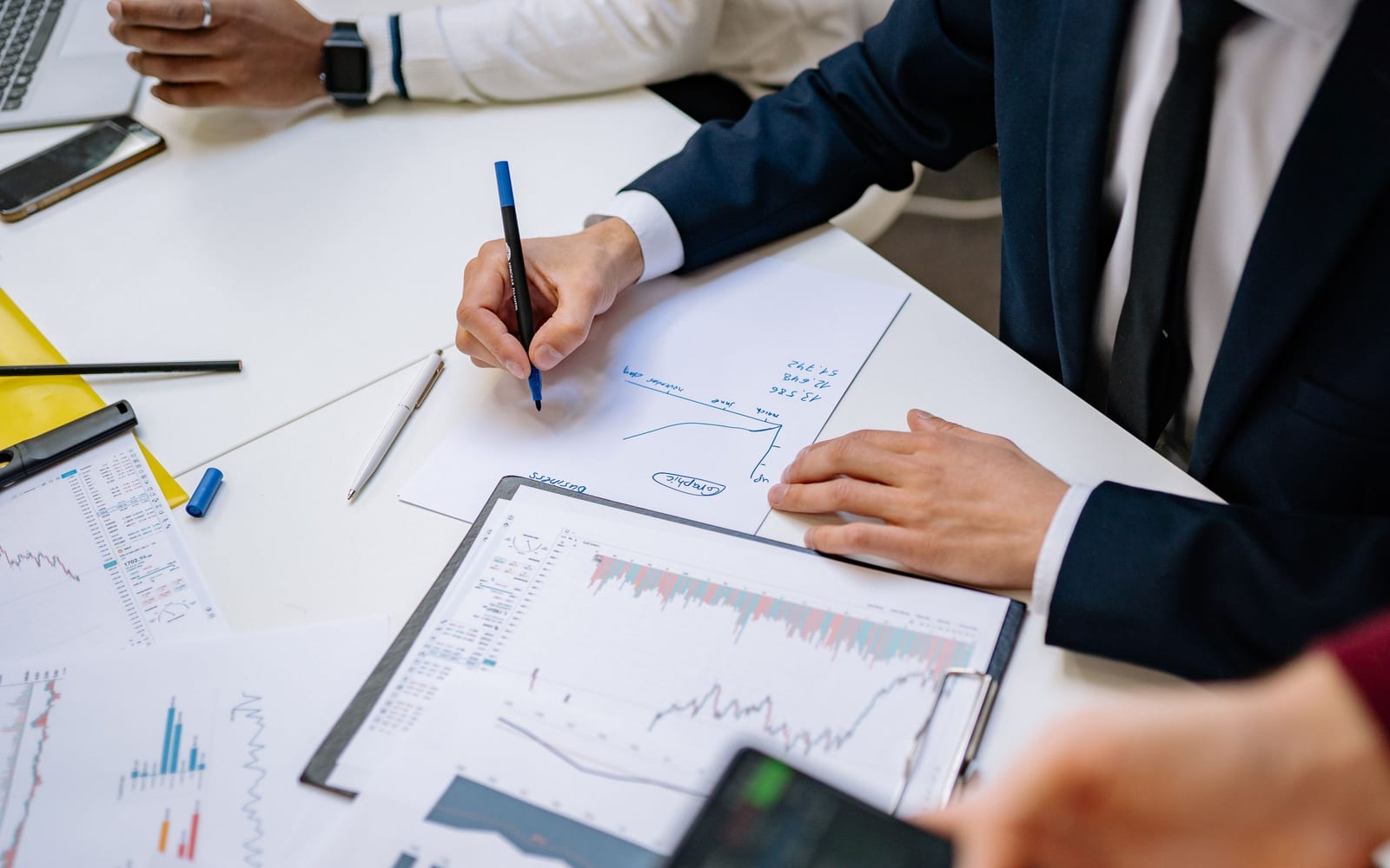 A finance meeting around a conference table.