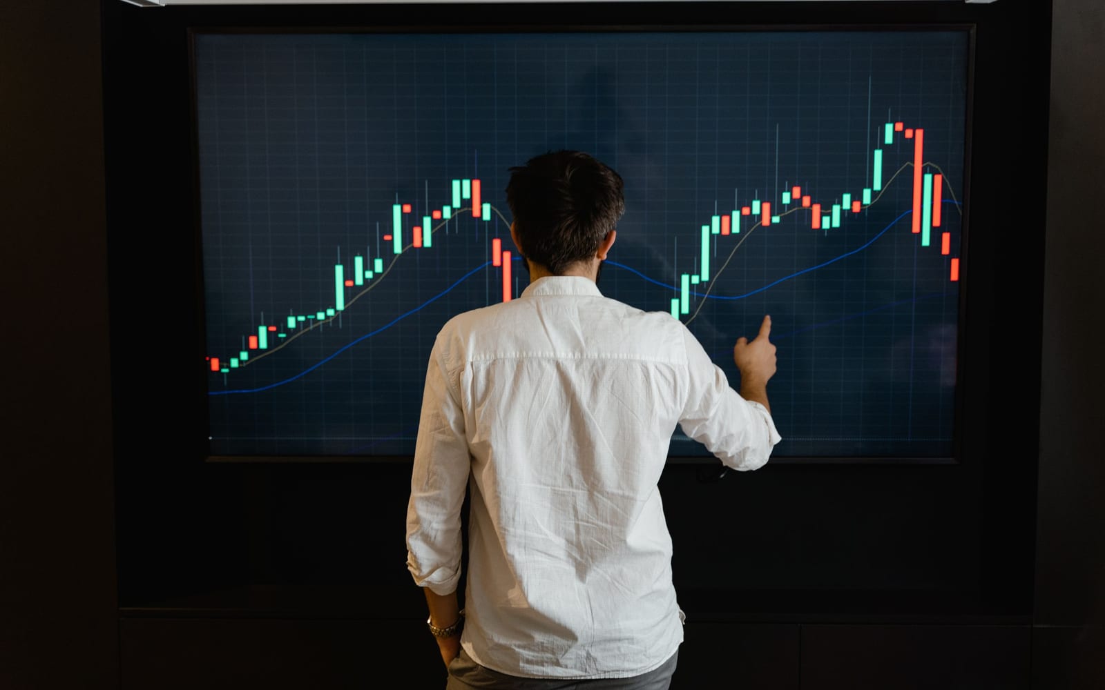 An analyst reviewing figures on a laptop in an office.