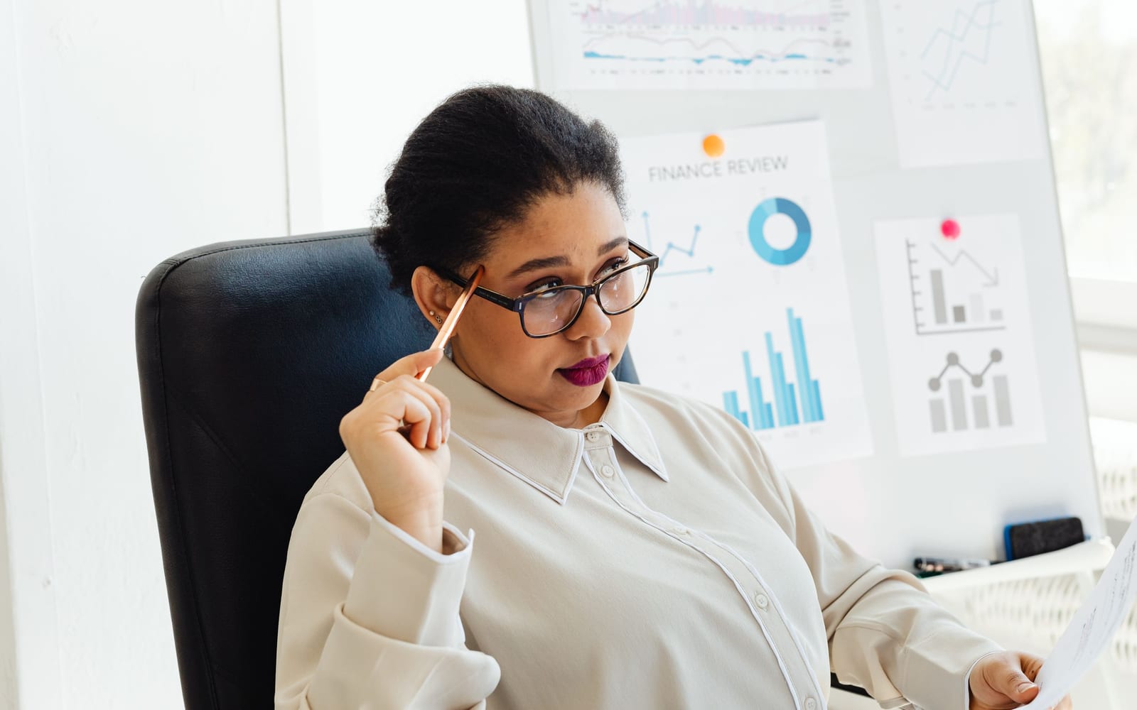 An analyst reviewing figures on a laptop in an office.
