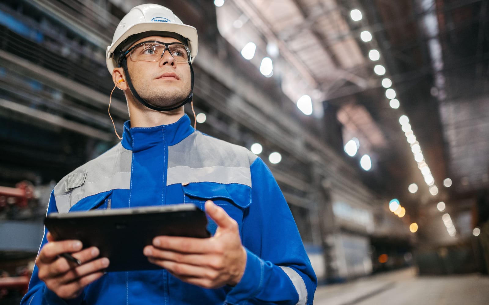 A technician using a tablet on a work site.
