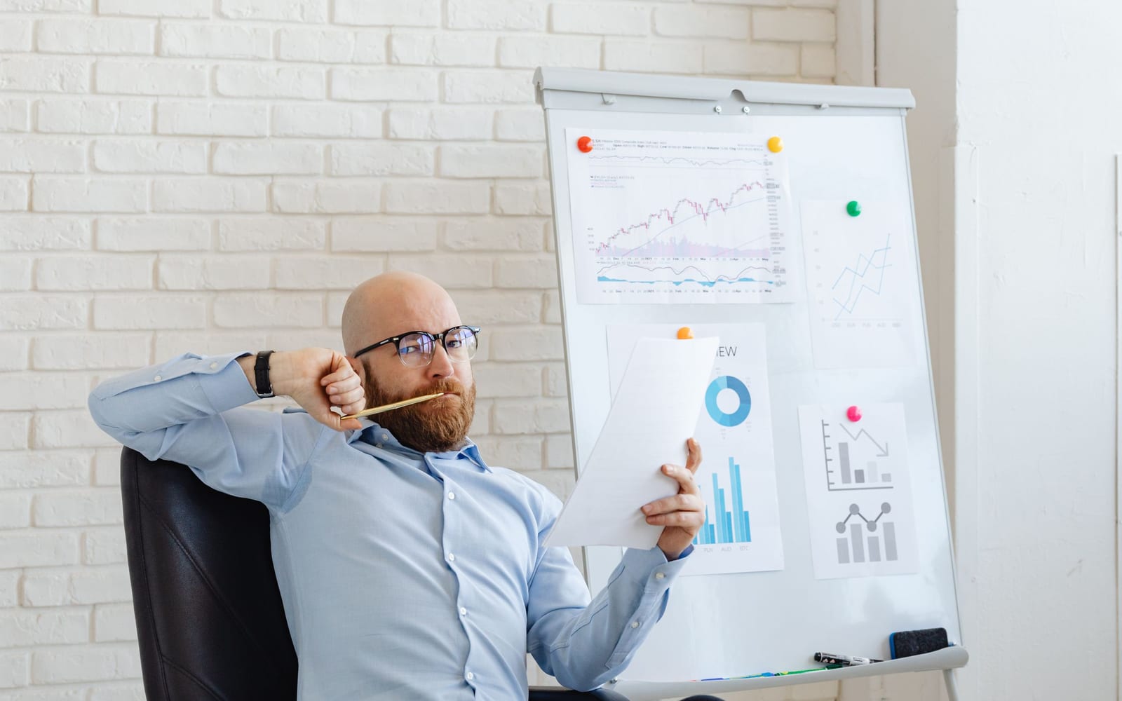 An analyst reviewing figures on a laptop in an office.