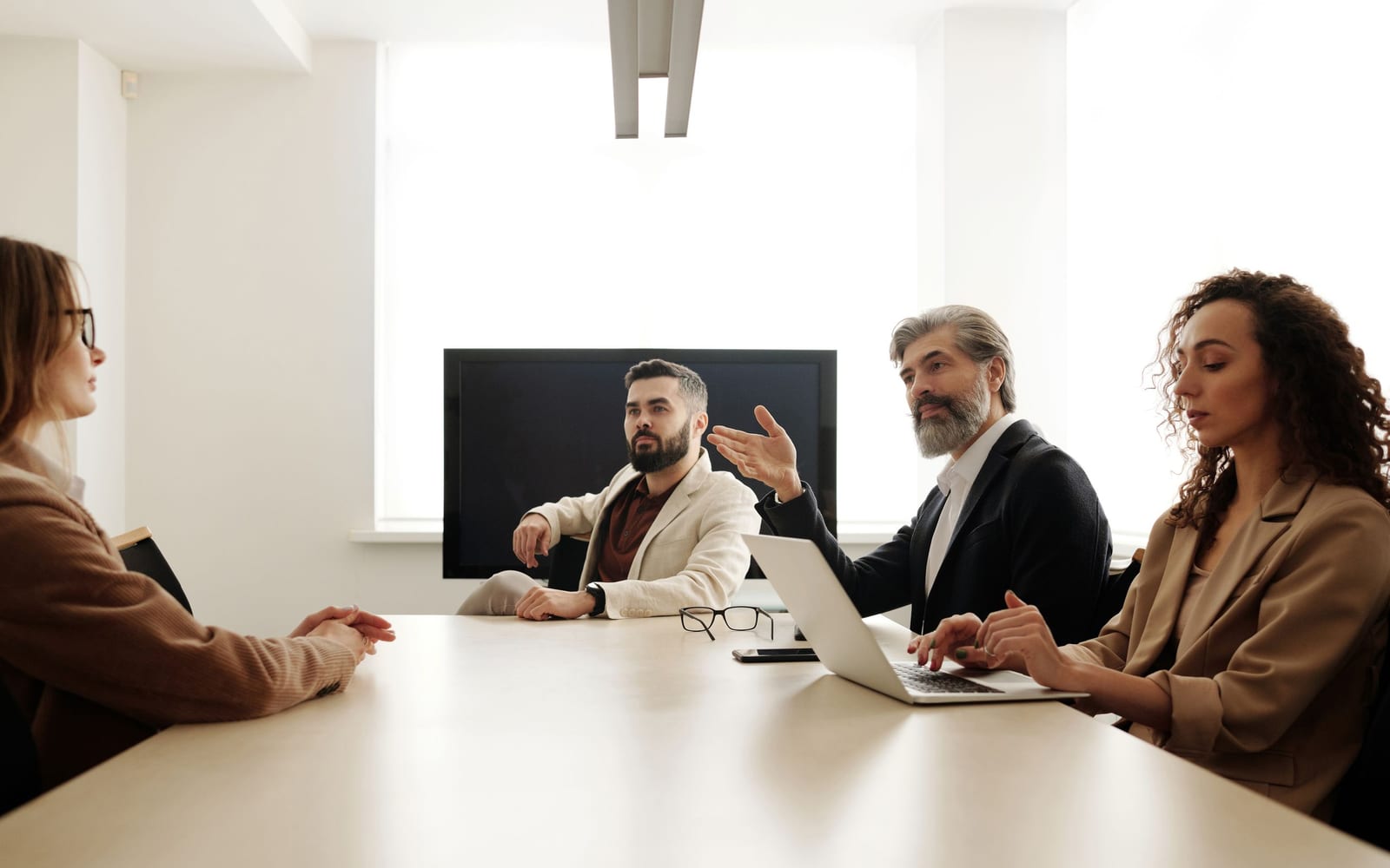 An enterprise meeting in a glass-walled conference room.