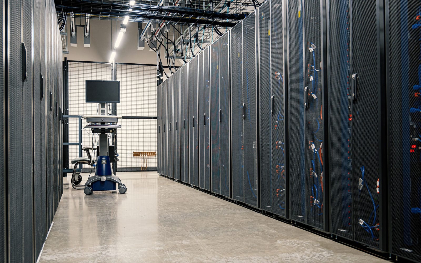 An engineer working beside servers in a data centre.