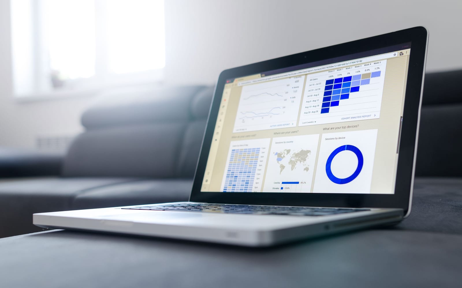 An analyst reviewing figures on a laptop in an office.