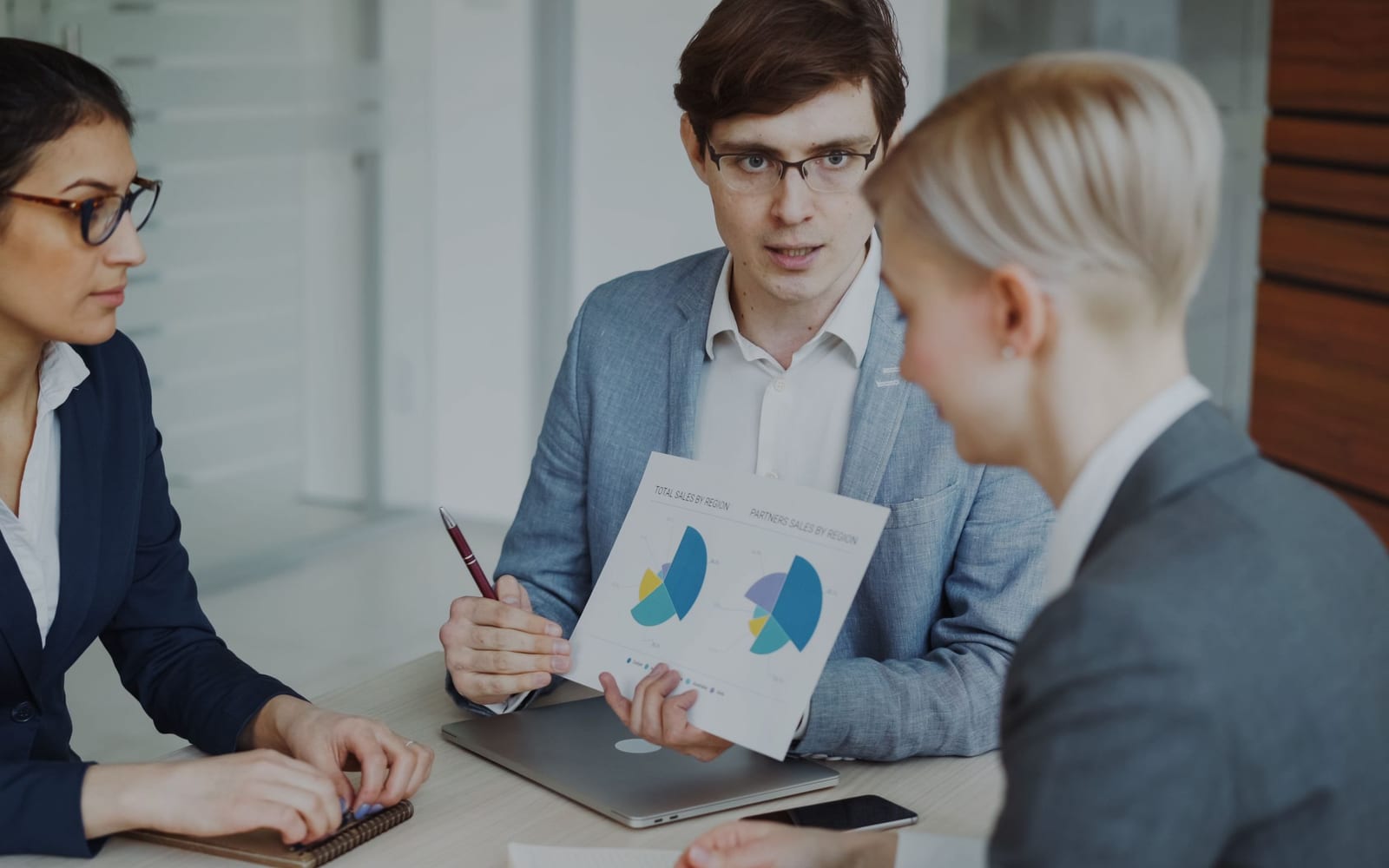 A finance meeting around a conference table.