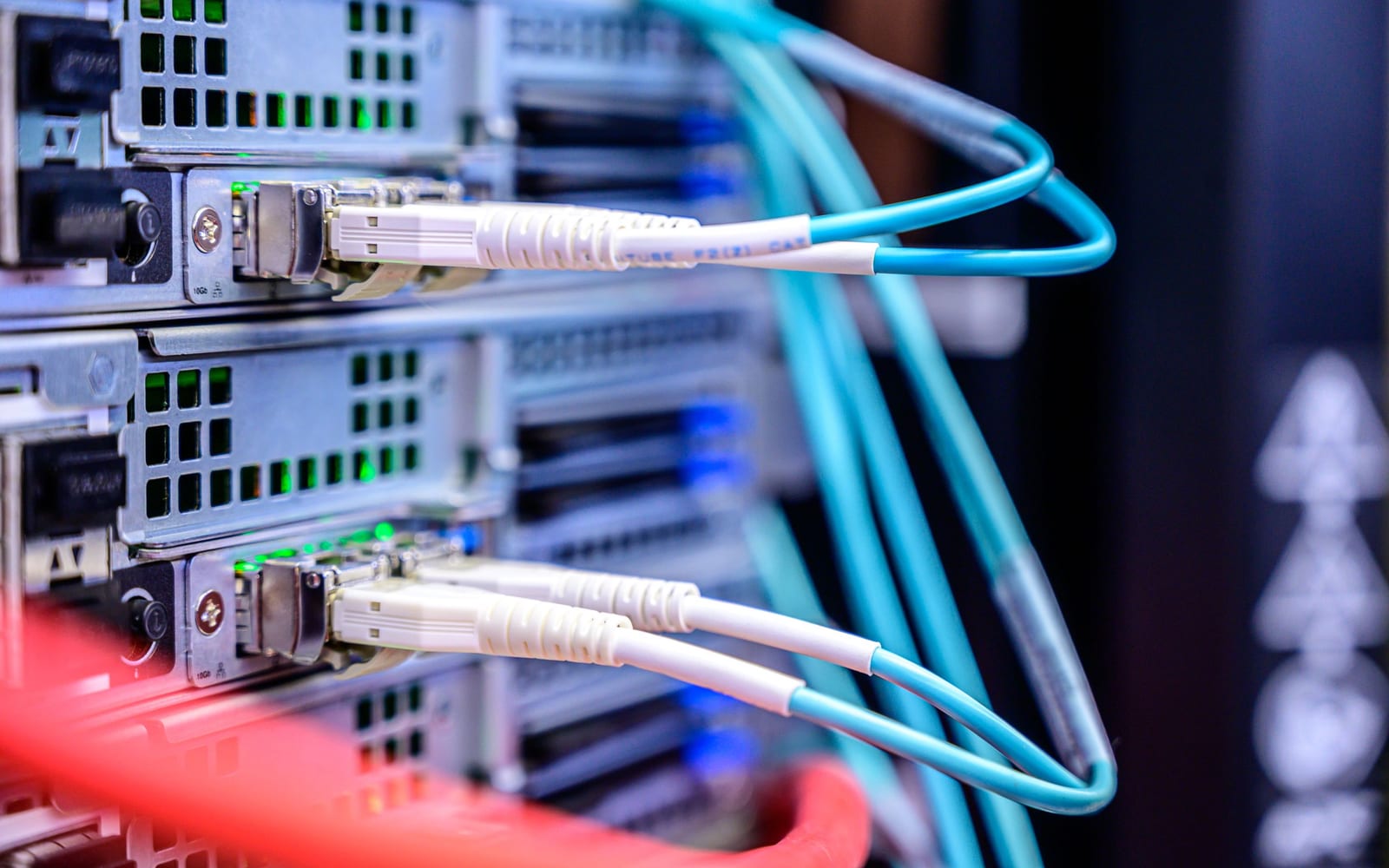 An engineer working beside servers in a data centre.