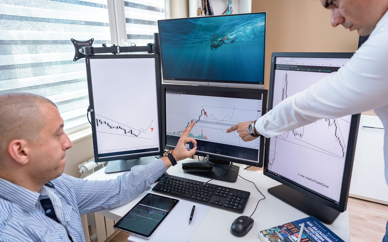 An analyst reviewing figures on a laptop in an office.